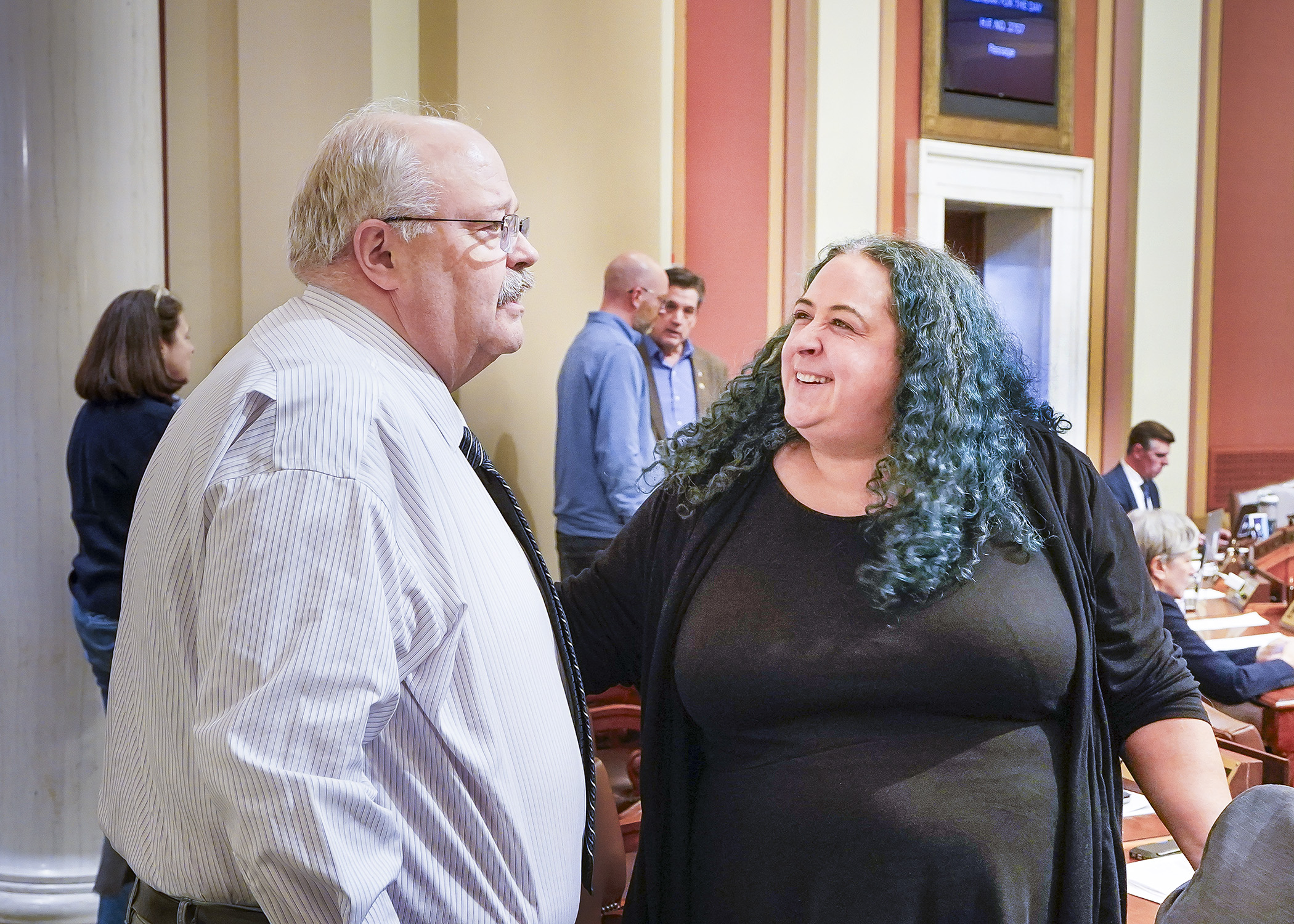 Rep. Greg Davids greets Rep. Aisha Gomez, who chairs the House Taxes Committee, following a 128-2 floor vote on a bill that would adjust individual income tax standard deduction amounts for tax year 2023. (Photo by Andrew VonBank)
